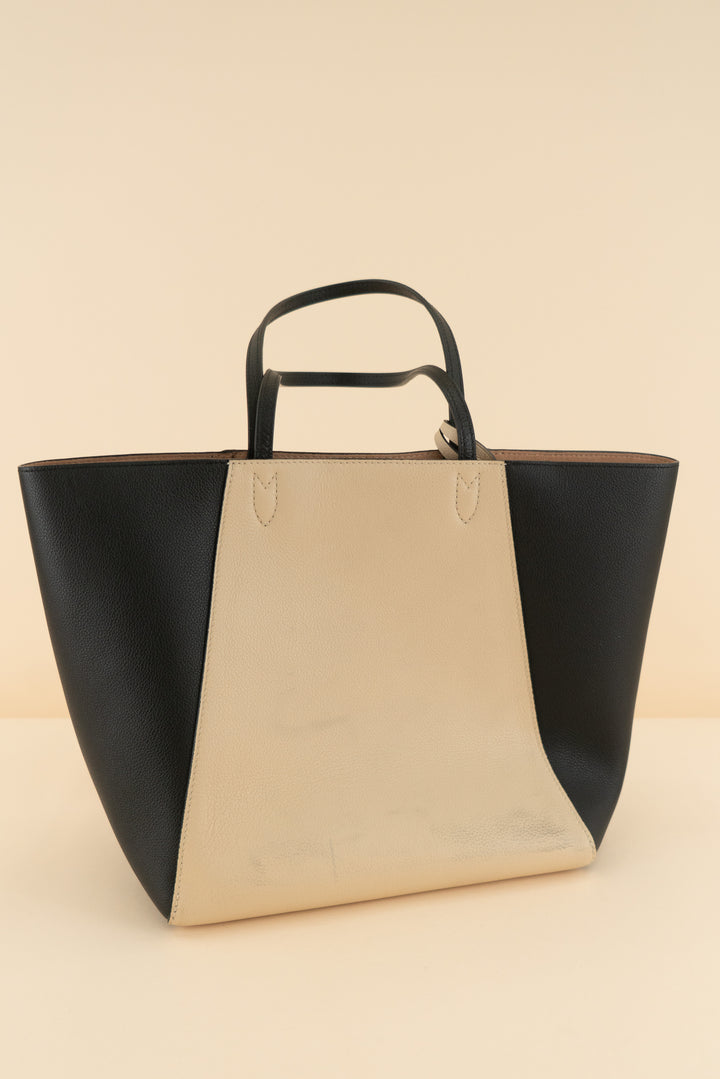 AUCTION louis vuitton black and cream lockme cabas leather tote bag (est. retail $3,250)