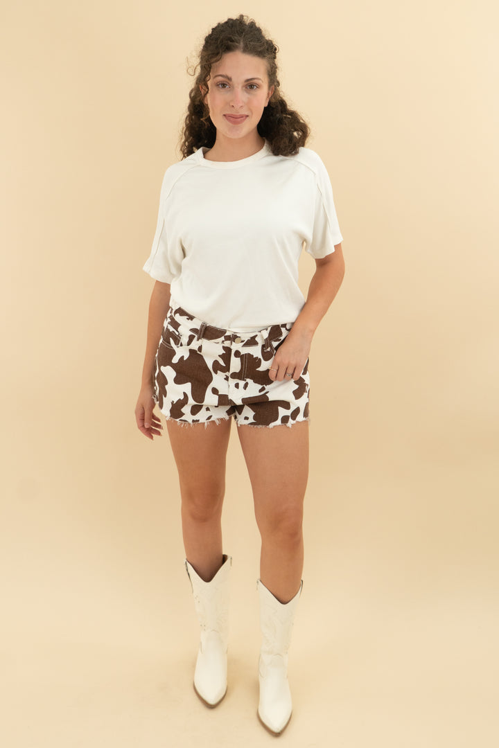 Brown cow print white denim shorts (m; retail $58)