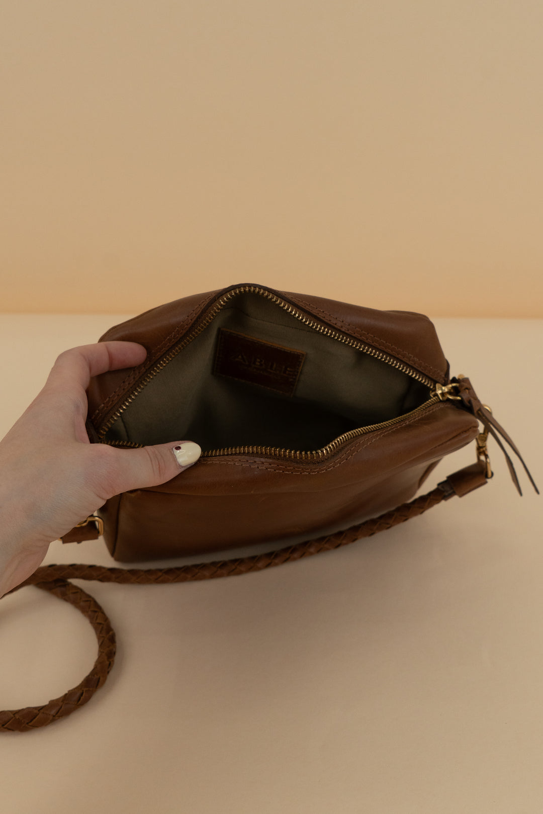 able brown crossbody with braided strap (os)