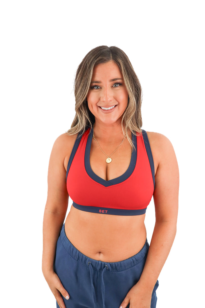 set active red sports bra with navy blue trim (M; retail $56)