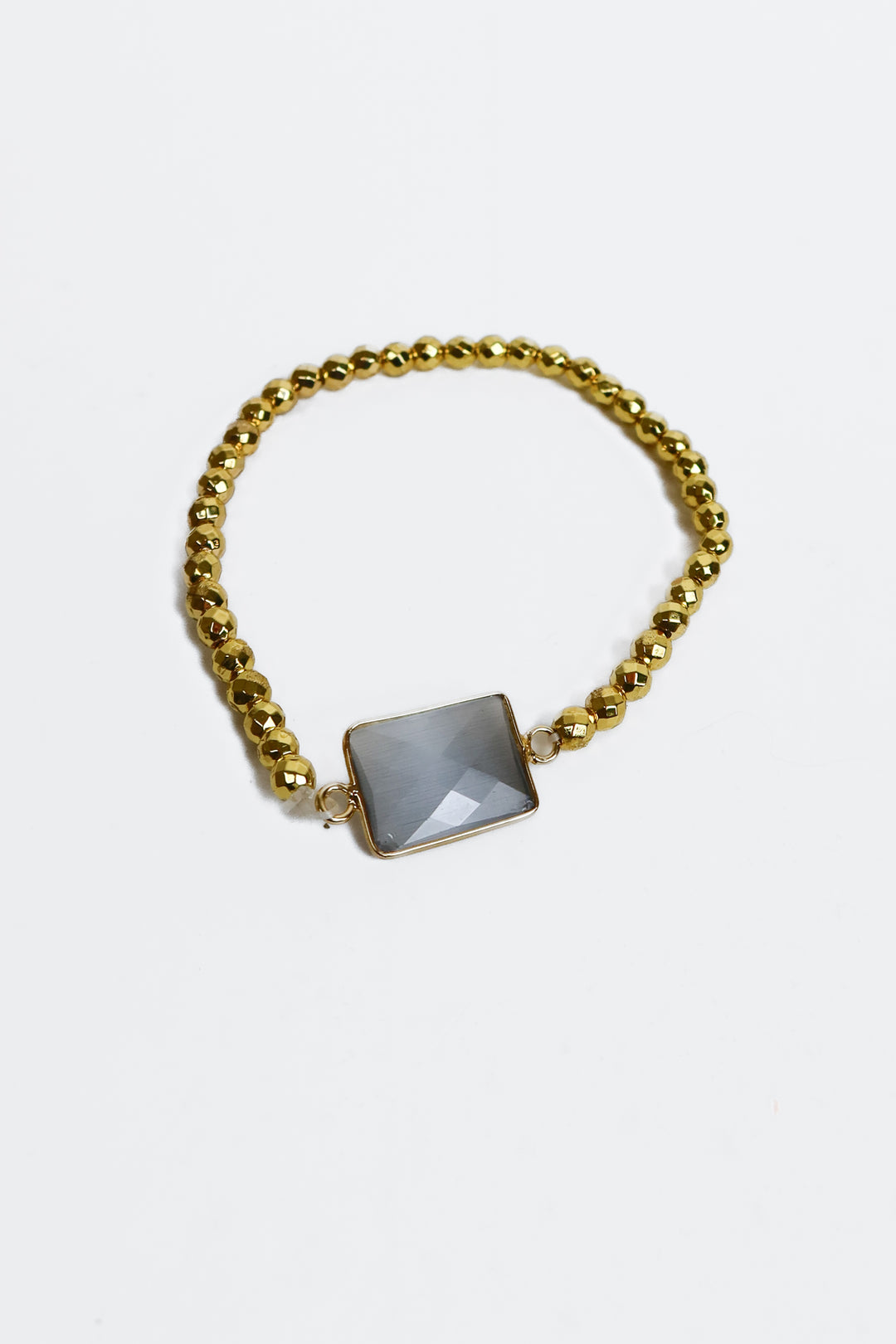 gold beaded bracelet with light purple gem
