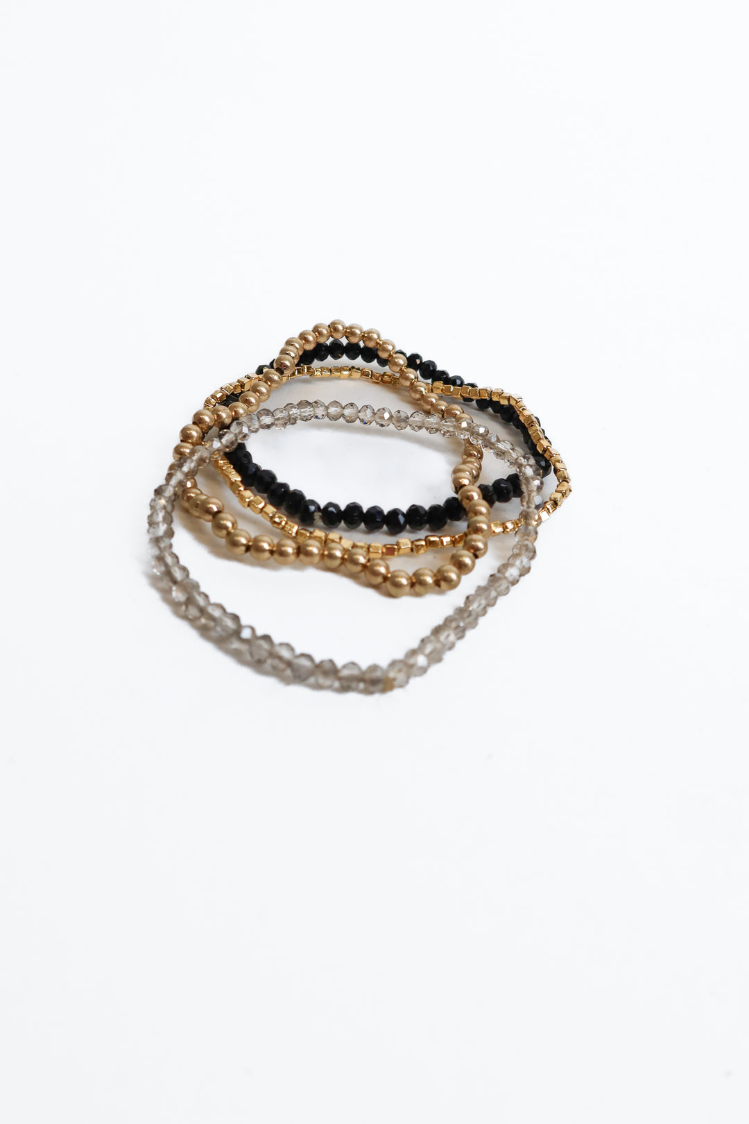 gold, black, and grey beaded bracelets