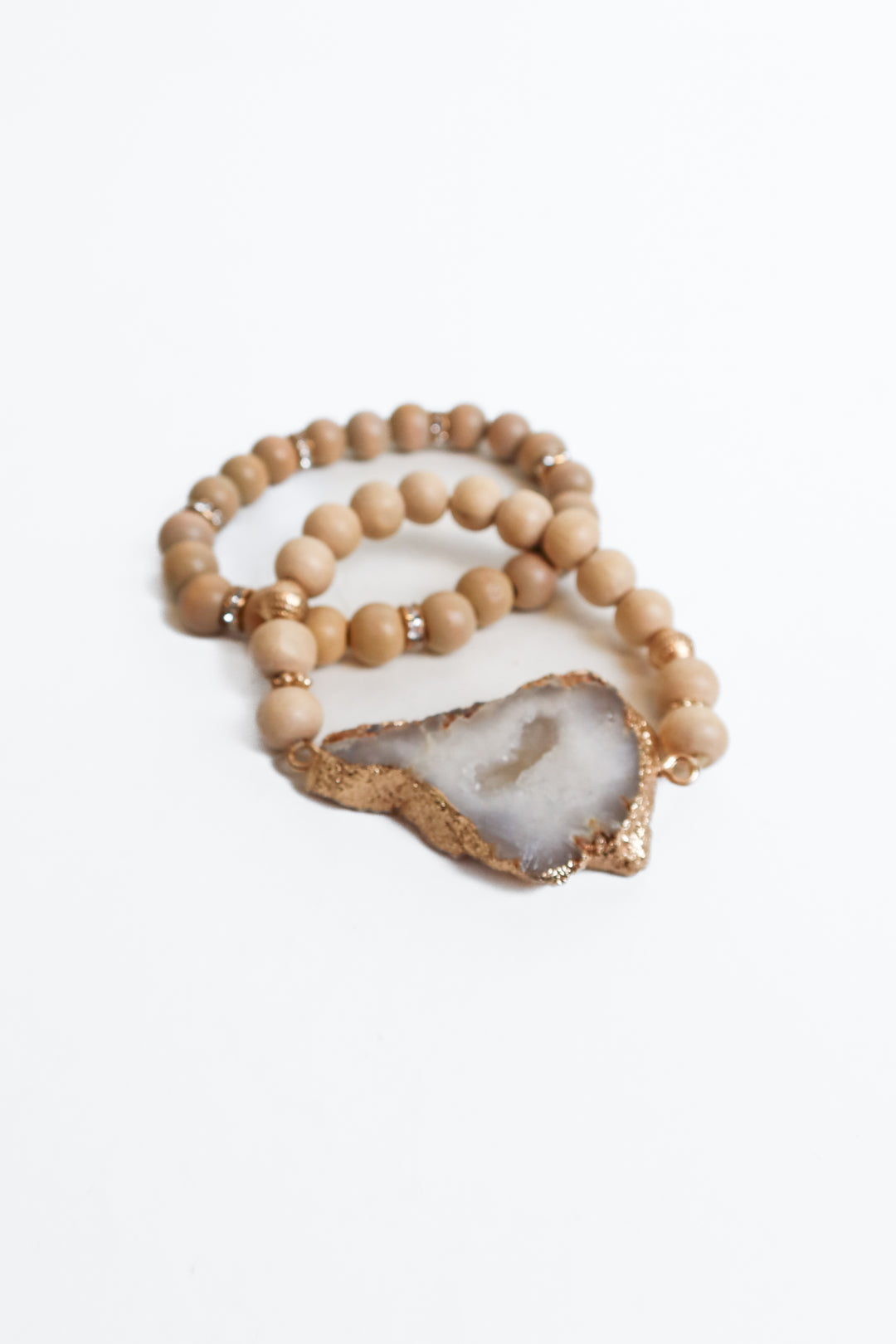 two earth tone bracelets with diamond and gem detail